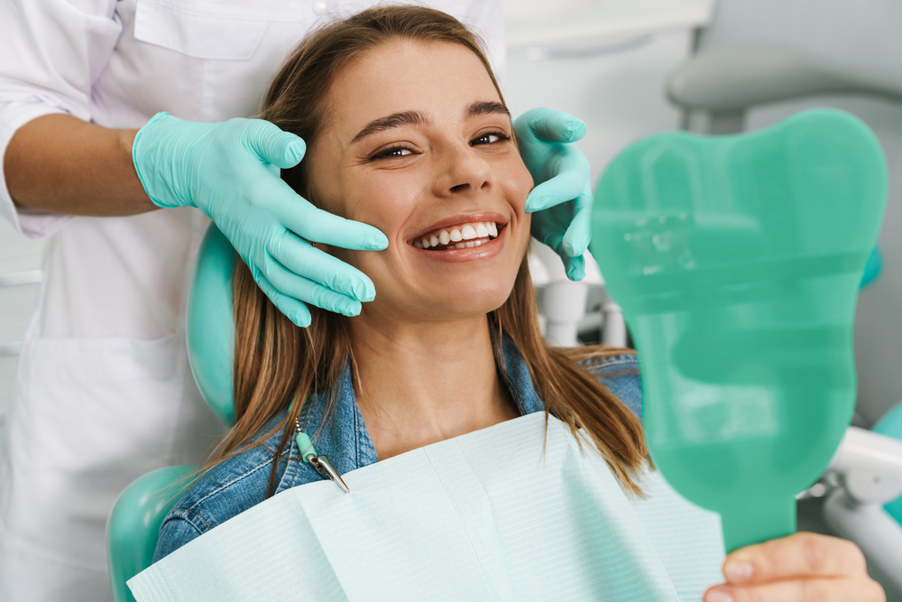 Dentist showing a patient oral health resources on a tablet